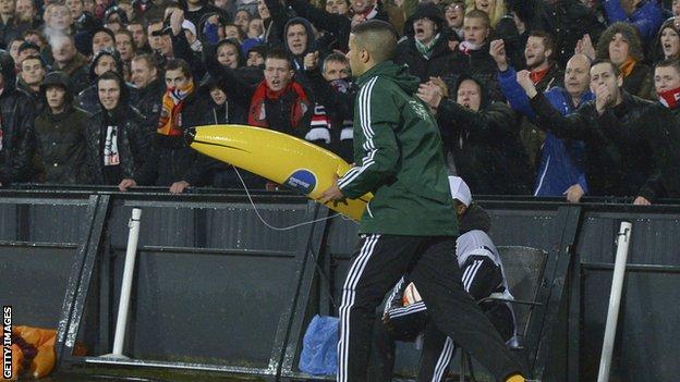 Fourth official carries an inflatable banana down the touchline