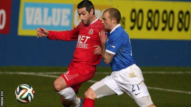 Keith O'Hara is challenged by Warren Feeney in Portadown 2-1 win at Windsor Park