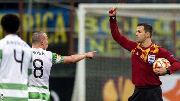 Celtic captain Scott Brown is booked by referee Ivan Kruzliakin