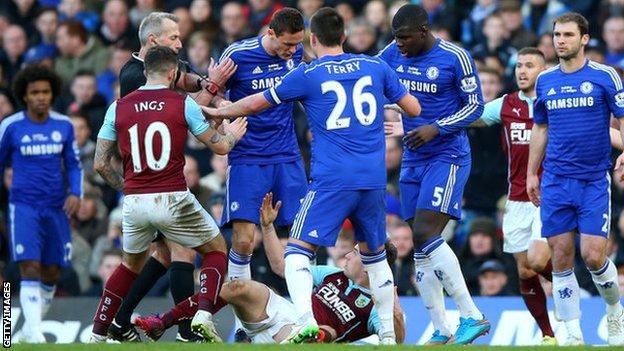 Chelsea midfielder Nemanja Matic clashes with the grounded Burnley forward Ashley Barnes
