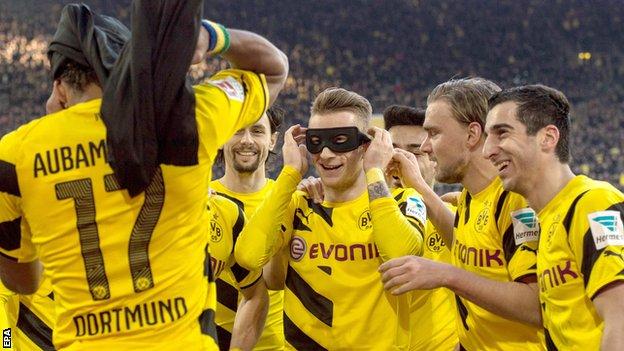 Borussia Dortmund players Pierre-Emerick Aubameyang and Marco Reus celebrate their team's first goal against Schalke