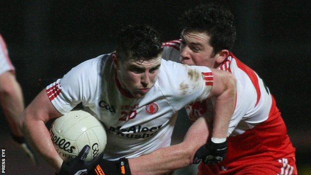 Tyrone's Connor McAliskey attempts to break away from Derry's Dermot McBride at Healy Park