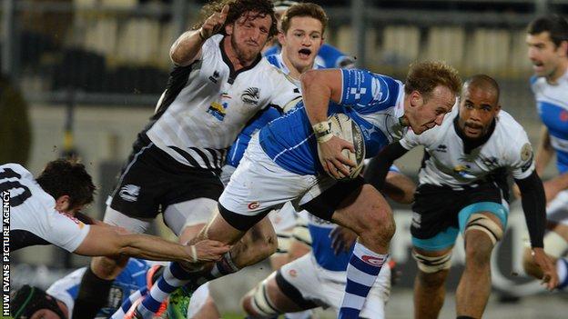 Ashley Smith on the attack for Newport Gwent Dragons is tackled by Zebre's Edoardo Padovani