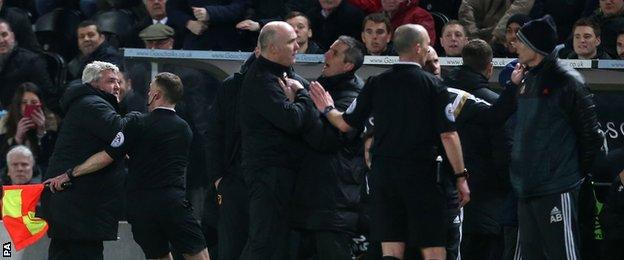 But then Bruce becomes upset and has to be restrained by an official and members of his coaching staff