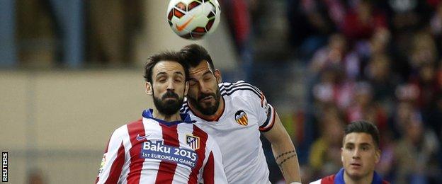 Valencia's Alvaro Negredo challenges Juanfran of Atletico Madrid
