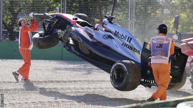 Danish driver Kevin Magnussen"s McLaren is removed from the circuit after crashing into a tire wall during the second practice session for the Australian Formula One Grand Prix at Albert Park in Melbourne