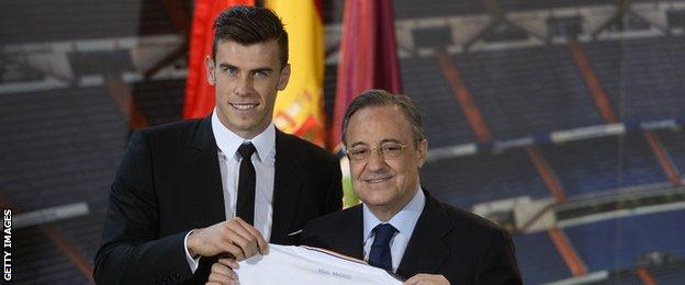 Gareth Bale holds up a Real Madrid shirt with his name on with President Florentino Perez