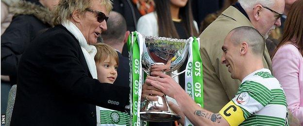 Scott Brown receives the trophy from Rod Stewart