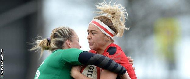 Wales centre Adi Taviner is tackled by Ireland captain Niamh Briggs at St Helen's
