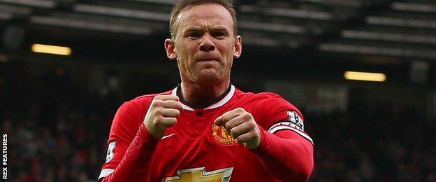 Wayne Rooney celebrates his goal by punching the air like a boxer