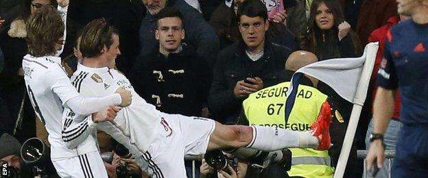 Gareth Bale kicks out at a corner flag as he celebrates scoring against Levante