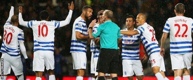 QPR players protest at Mike Dean's decision