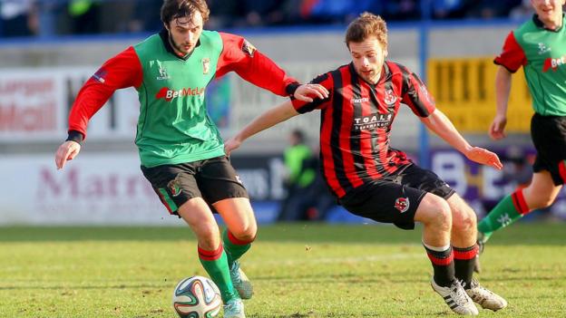 Glentoran's Fra McCaffrey in possession as Crusaders opponent Nathan Hanley moves in to challenge during the Irish Cup semi-final