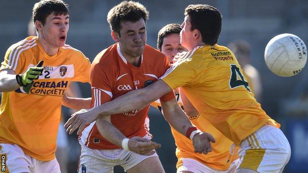 Armagh's Calum McComiskey comes up against Antrim duo Conor O'Rawe and Gerard McCorley