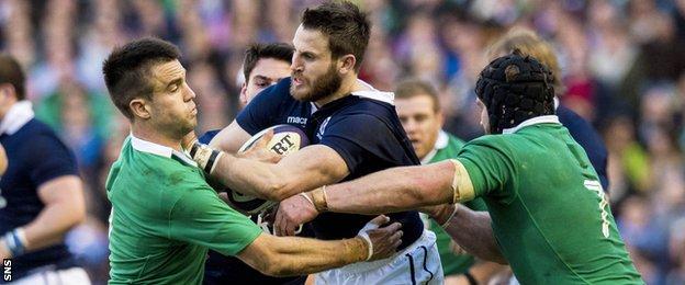 Scotland's Tommy Seymour (centre) tries to drive forward against Ireland