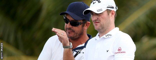 Marc Warren (right) in discussion with his caddie Ken Herring