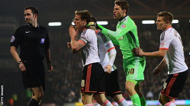 Fulham's Scott Parker, Marcus Bettinelli and Shaun Hutchinson appeal to referee Chris Kavanagh after Kostas Stafylidis was sent off in their defeat by Leeds