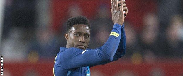 Danny Welbeck applauds Man Utd fans for their reception after being substituted after his winning goal for Arsenal in their FA Cup quarter-final