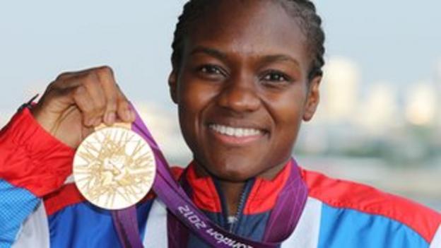 Olympic women's flyweight boxer Nicola Adams stands proudly with her gold medal
