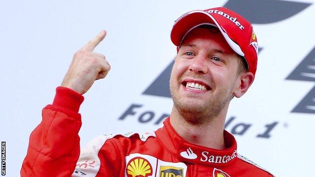 Sebastian Vettel holds up his finger to show he is number one