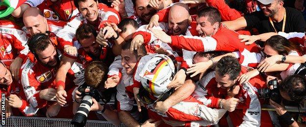 Sebastian Vettel celebrates with his Ferrari colleagues