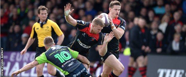 Gareth Anscombe (L) tackles Jack Dixon (C) as Hallam Amos (R) breaks free