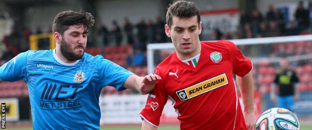 Portadown's Sean Mackle in action against David McDaid of Cliftonville