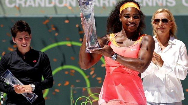 Serena Williams is presented with the Miami trophy by Martina Navratilova
