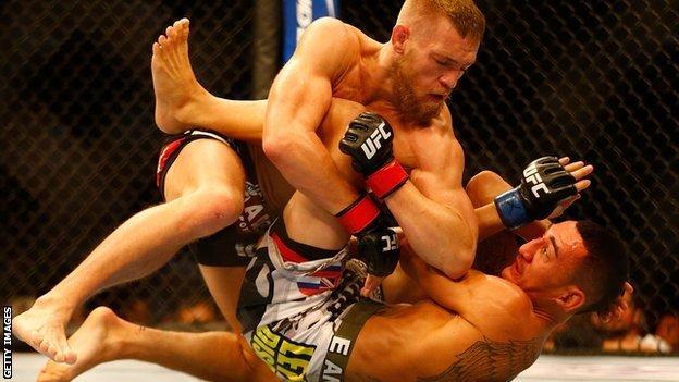 Conor McGregor fighting Max Holloway in August 2013