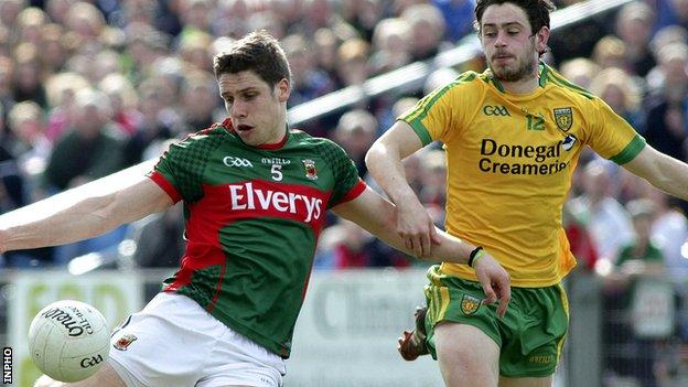 Mayo's Lee Keegan gets a shot in as Ryan McHugh of Donegal closes in