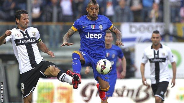 Parma players tackling Juventus' Vidal
