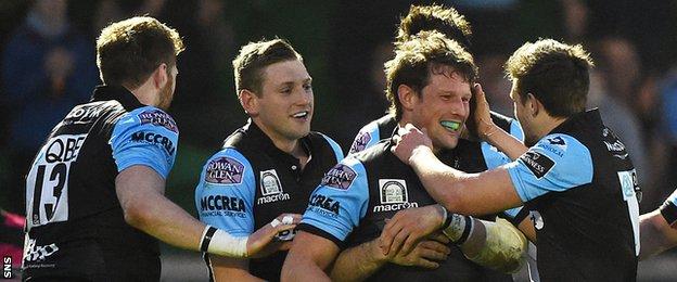 Peter Horne (2nd right) is mobbed by his Glasgow team-mates as they celebrate his hat-trick against Cardiff Blues