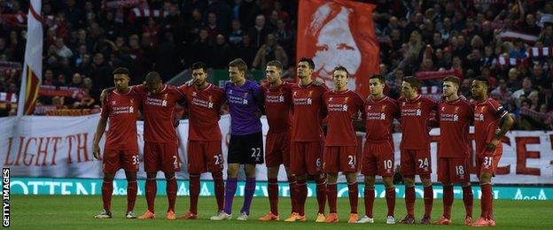 Liverpool players observe a minute's silence