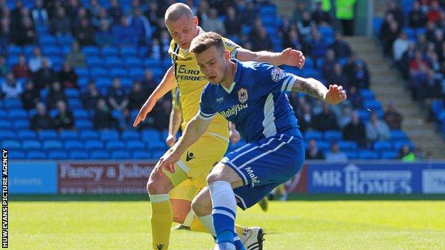 Cardiff City's Joe Ralls takes on Millwall's Alan Dunne