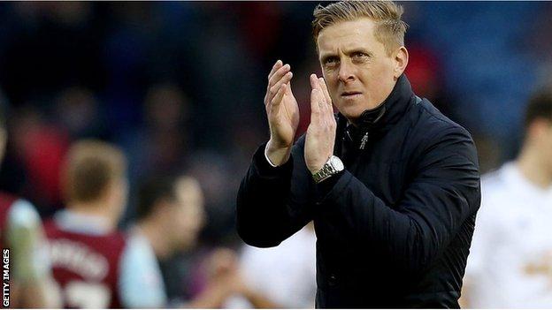 Swansea City manager Garry Monk applauds the fans