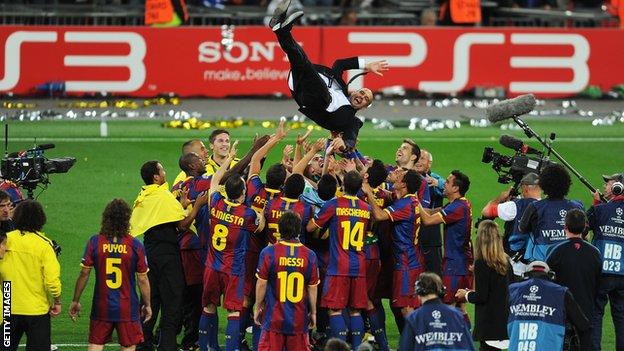 Barcelona players throw Pep Guardiola into the air