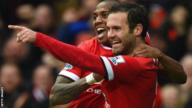 Ashley Young and Juan Mata celebrate during Manchester United's win over Manchester City