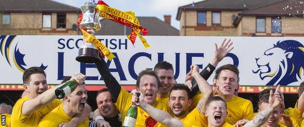 Albion Rovers players celebrate with the Scottish League Two trophy