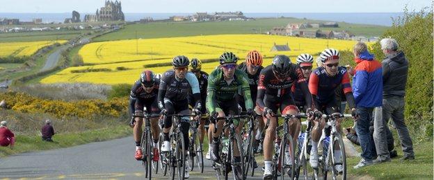 The peleton in the Tour de Yorkshire passes Whitby Abbey