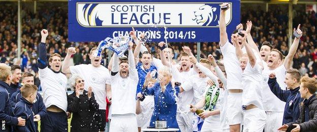 The Morton players lift the League One trophy at Cappielow