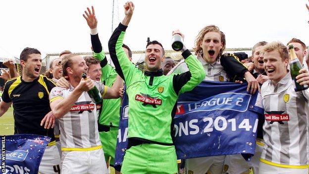 Burton Albion's players celebrate the League Two title