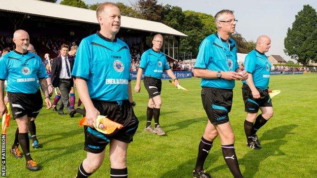 David Mitchell leads out the officials for the Camanachd Cup final