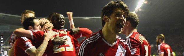 George Friend of Middlesbrough celebrates as Patrick Bamford is congratulated by team-mates behind him