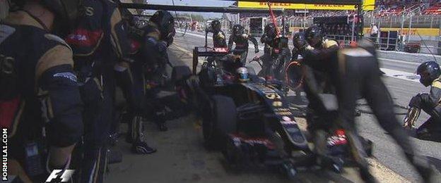 A Lotus engineer is flung in to the air during a pit stop