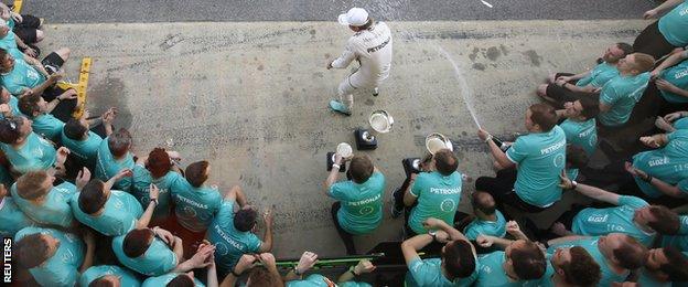 Nico Rosberg is sprayed with Champagne by his Mercedes team