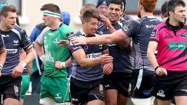 Ospreys players congratulate Rhys Webb after scoring a try against Connacht