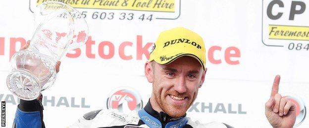 Lee Johnston celebrates his Superstock victory at the North West 200