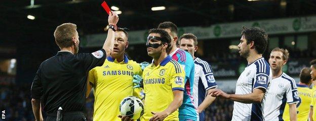 Cesc Fabregas is shown the red card by Mike Jones