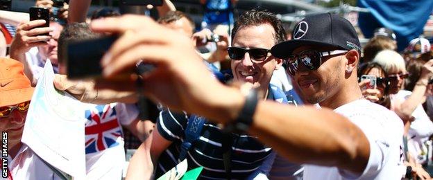 Mercedes F1 driver Lewis Hamilton poses with fans at the Monaco Grand Prix