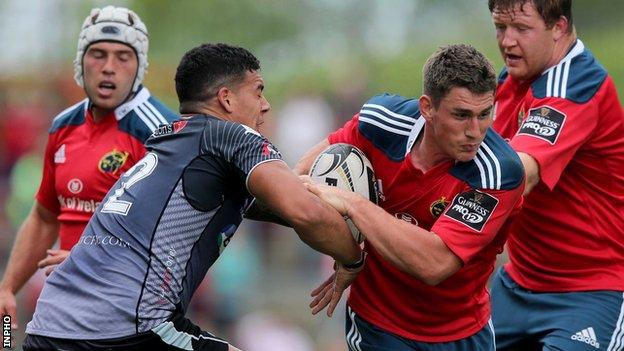 Ian Keatley attempts to get past Josh Matavesi at Thomond Park